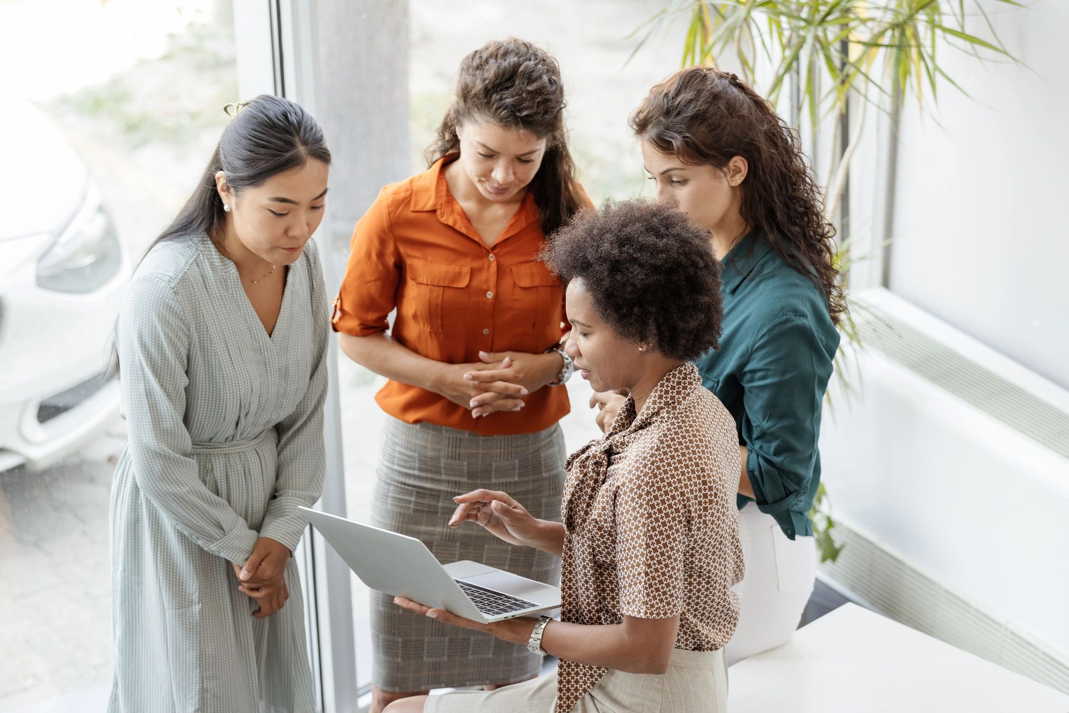 Women in a collaborative discussion at a modern office