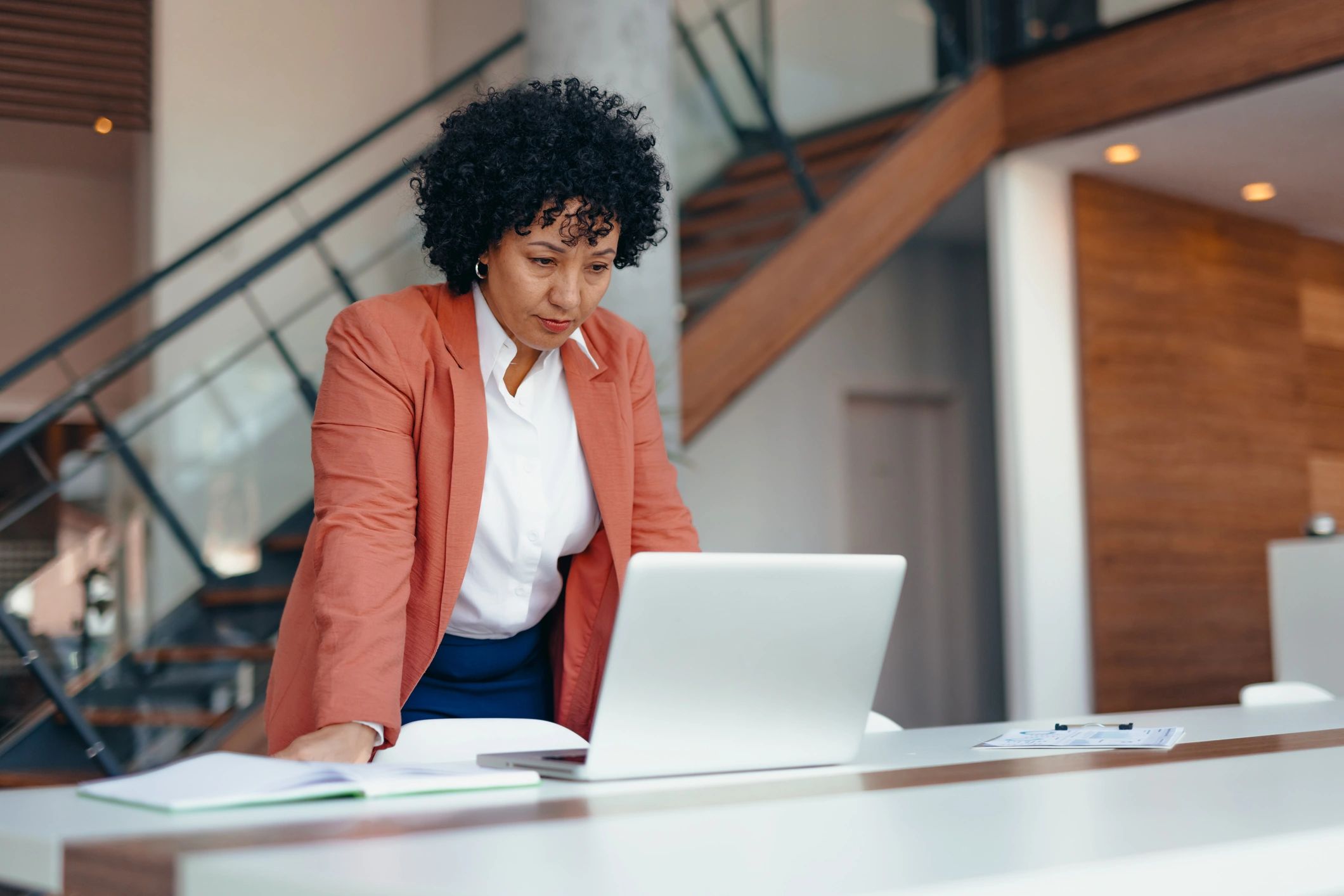 Woman working on a laptop, representing career mentorship and coaching