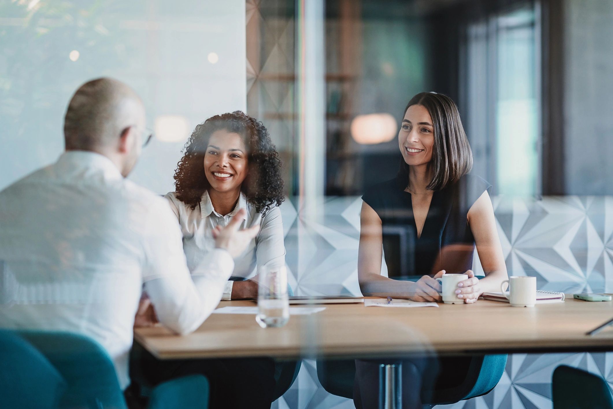Mentorship meeting behind a glass wall