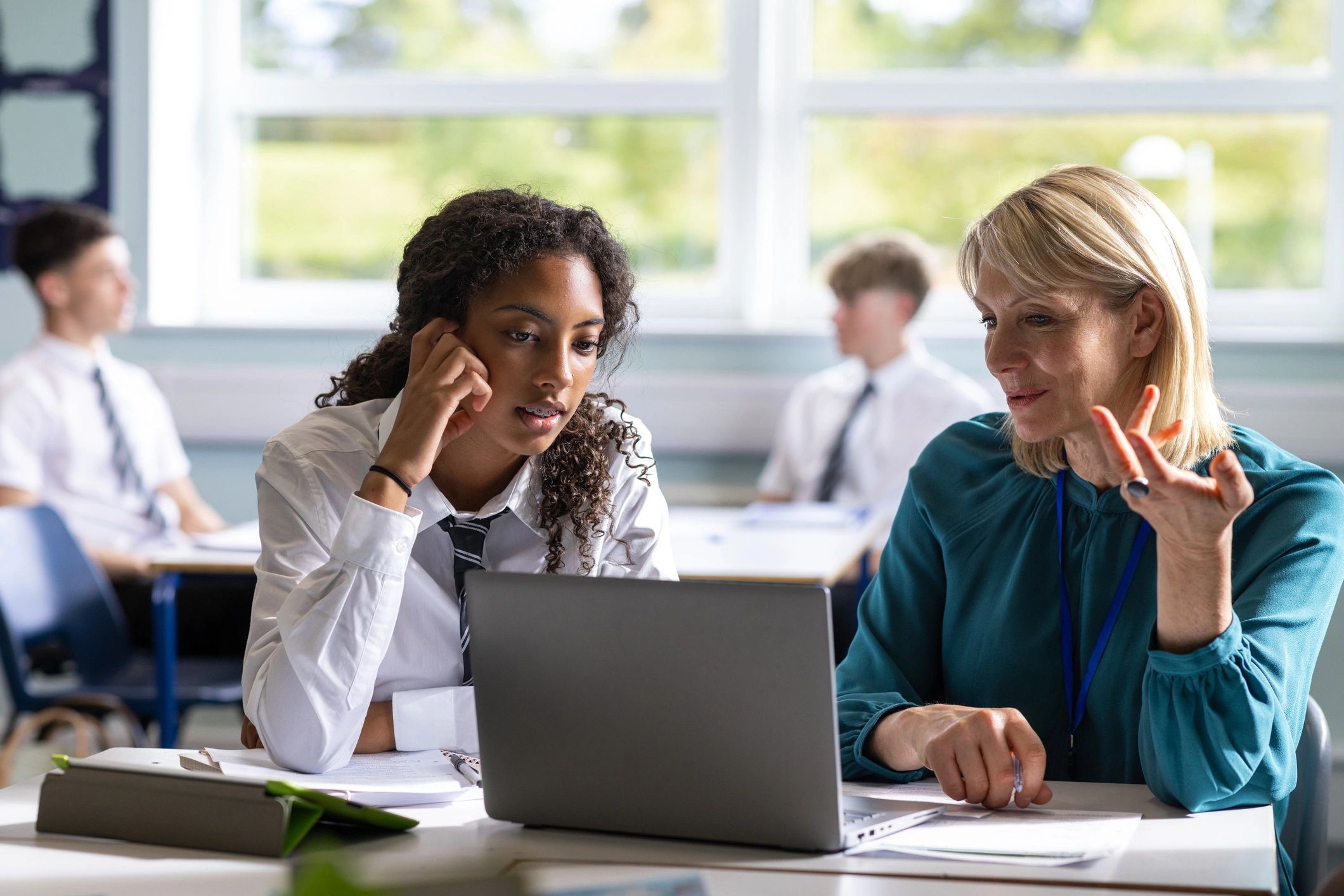 Mentor and mentee collaborating on a laptop