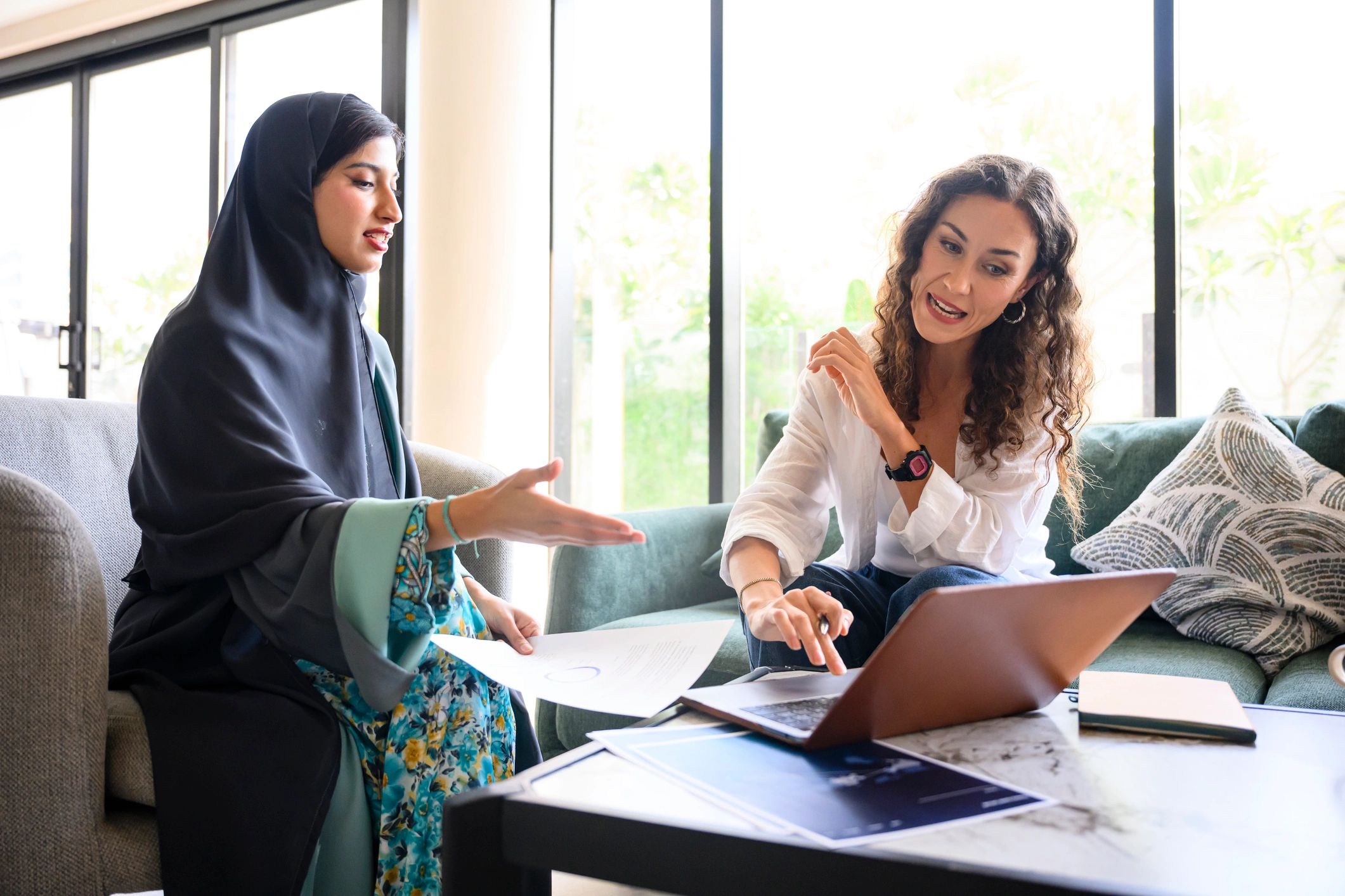 Two professionals collaborating on a laptop during a mentorship conversation